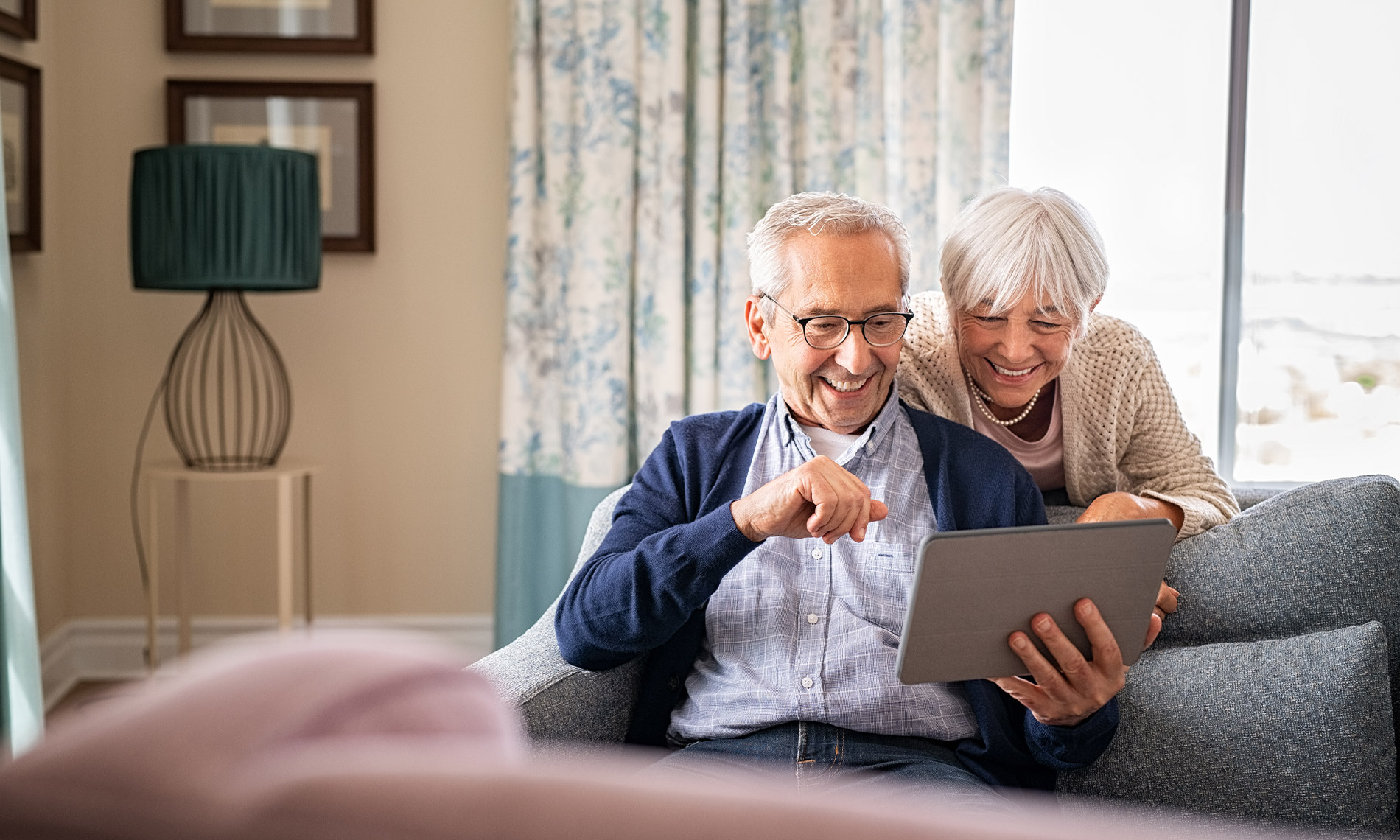 Elderly couple looking at tablet
