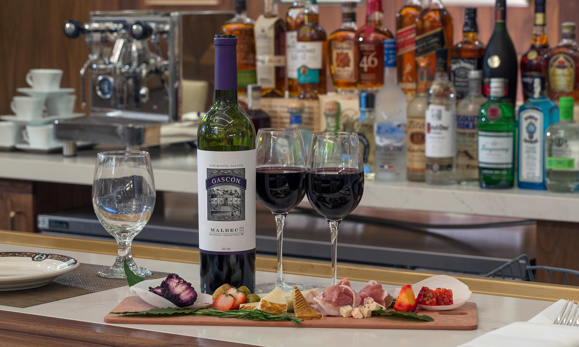 Wine and cheese board set on top of a bar