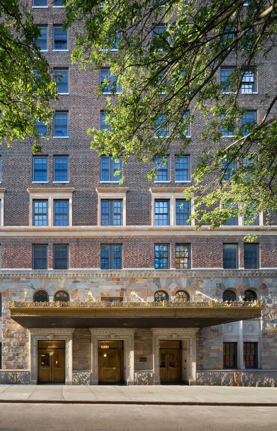 Exterior shot of the main entrance showcasing the intricate details of the golden canopy of the Watermark at Brooklyn Heights