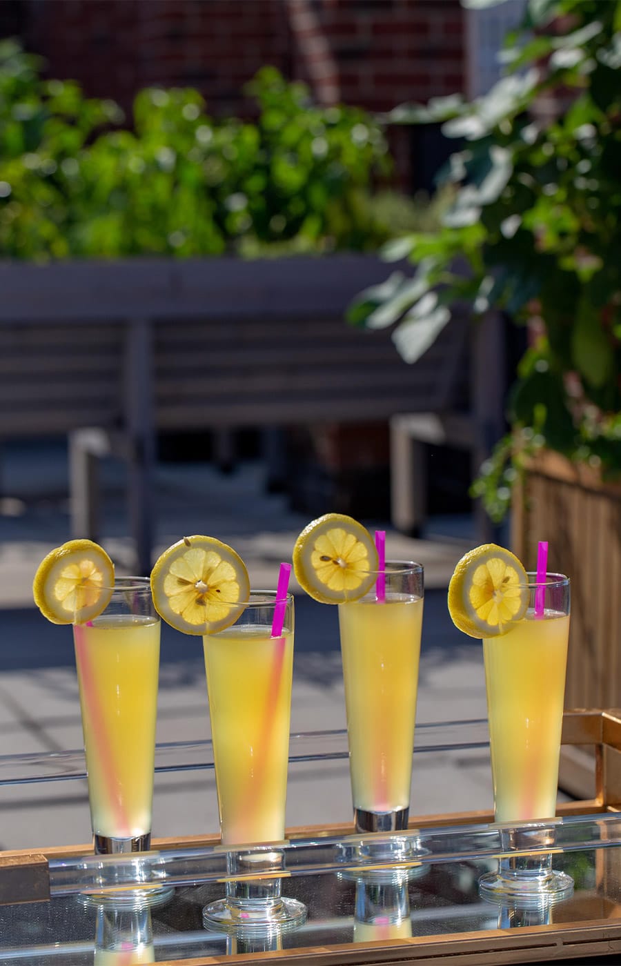 A quartet of beverages on top of the table on at the rooftop lounge of the Watermark at Brooklyn Heights