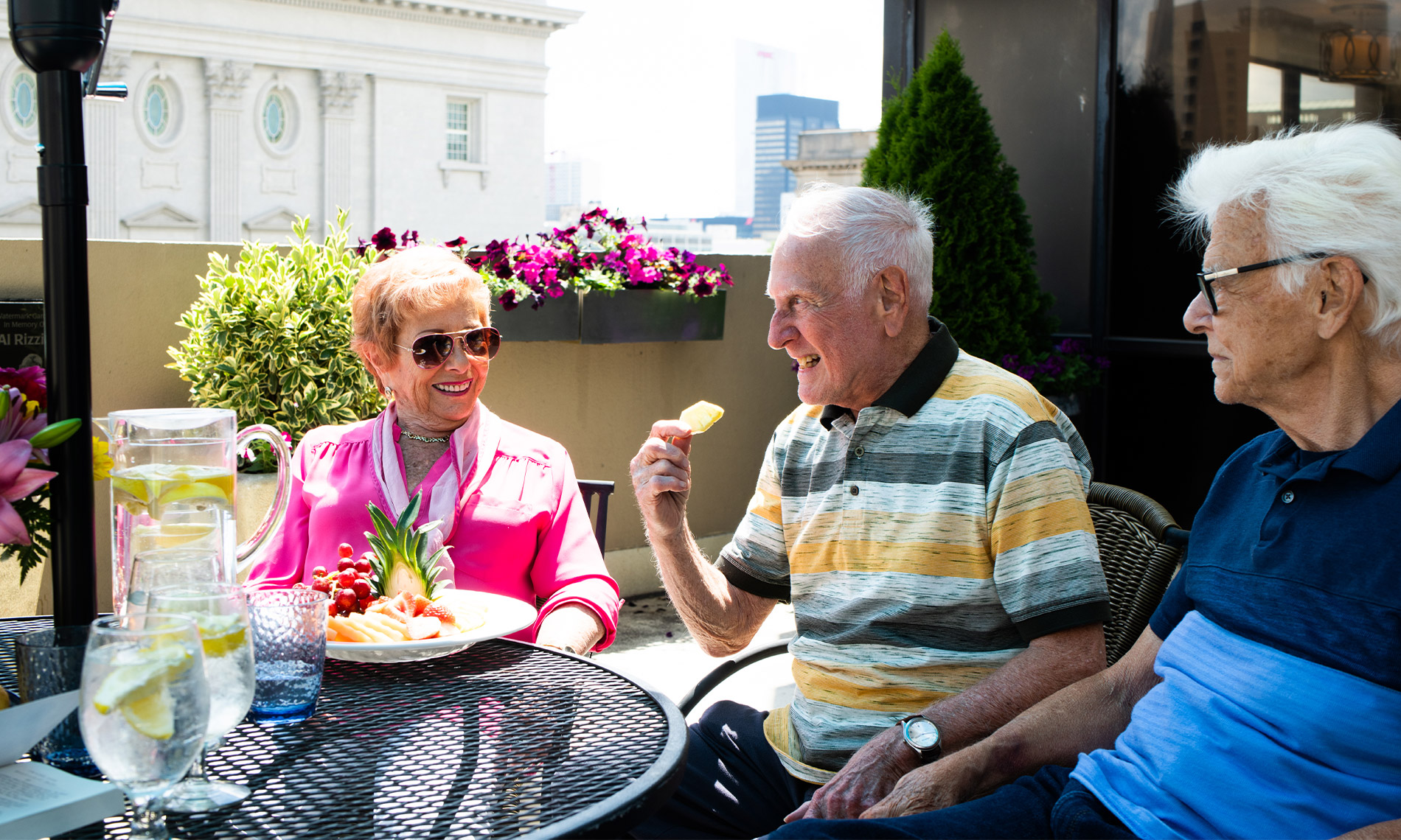 Group of seniors at a table outdoors visiting