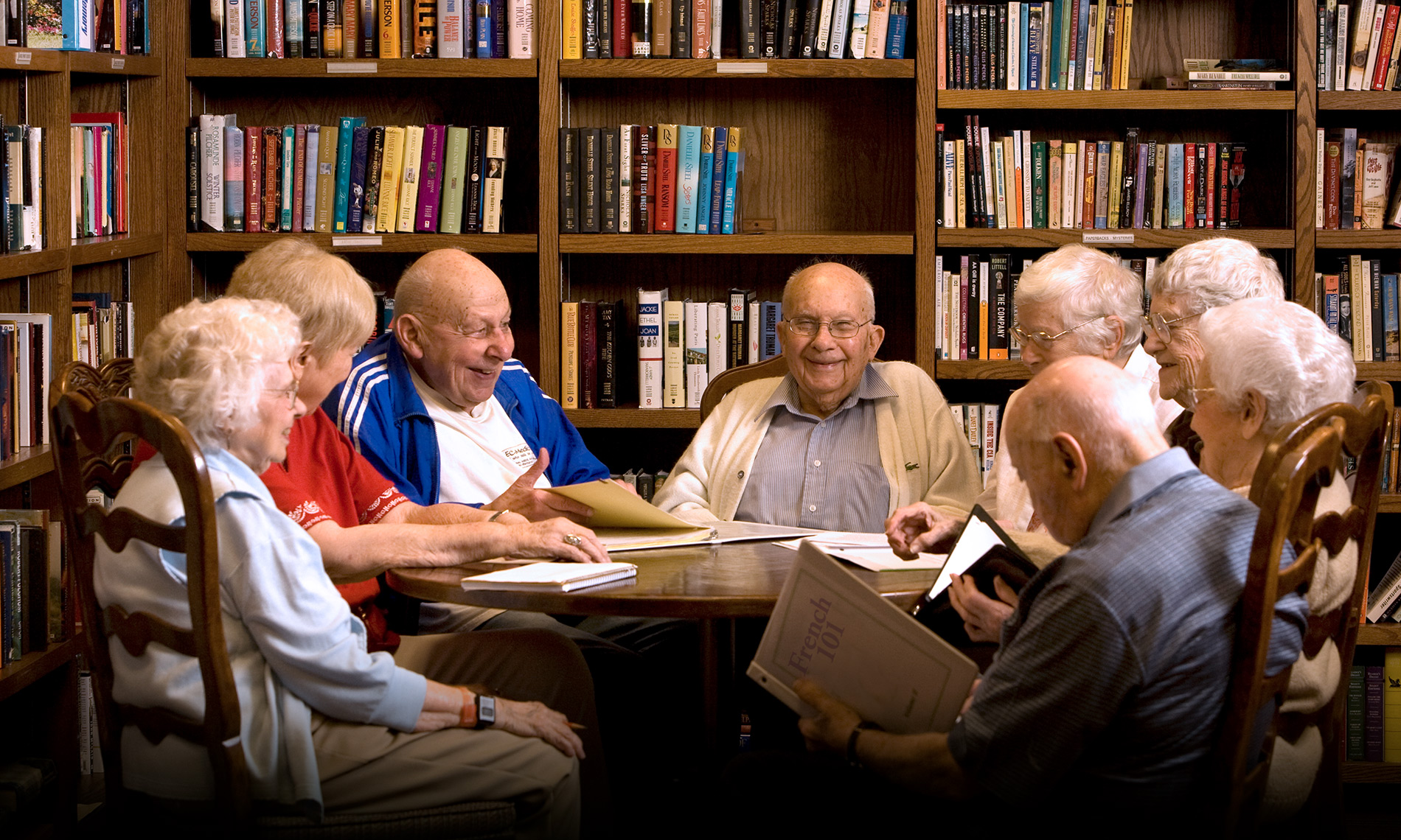 A group of seniors partaking in a painting workshop with an instructor