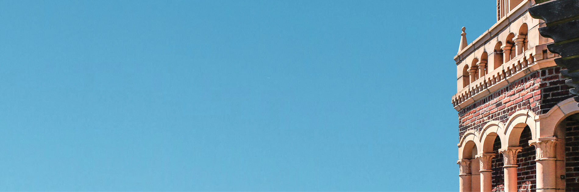 blue sky and portion of a brick tower
