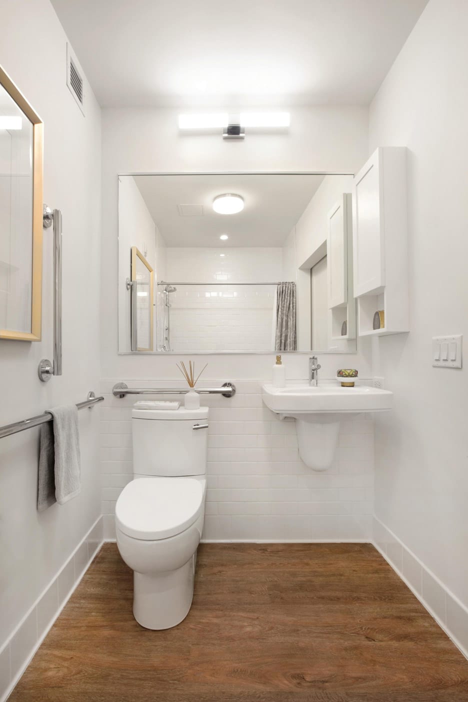 Brooklyn Heights Independent & Assisted Living Photo Gallery - a look at the toilet, sink, and hand rails for added support and safety