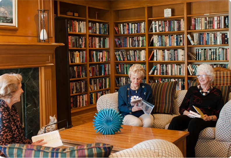 elderly woman sitting in a library