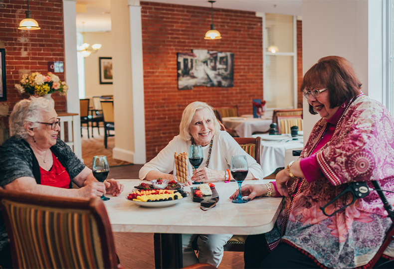 group of watermark residents talking over a glass of wine