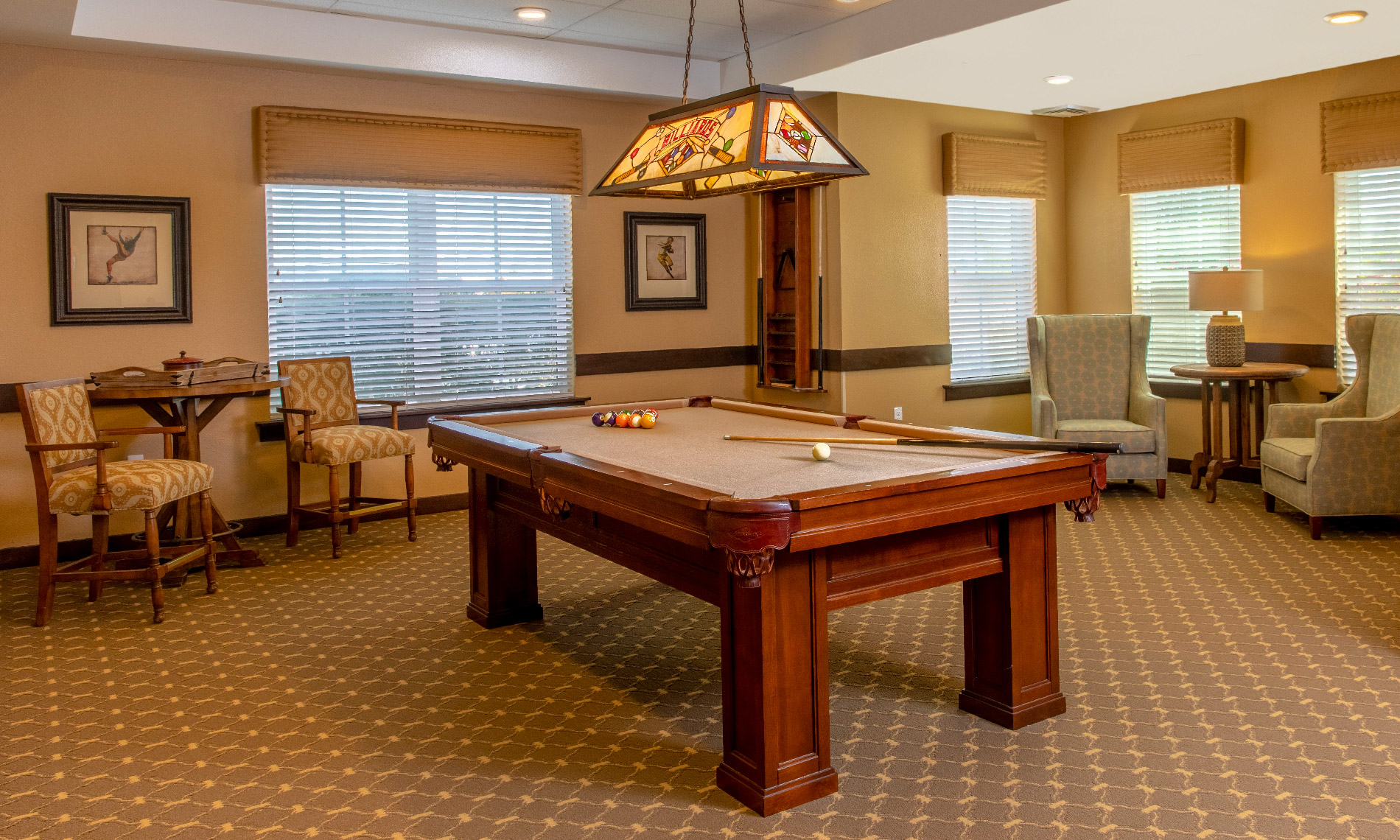 The pool table room, with an antique chandelier overlooking the table
