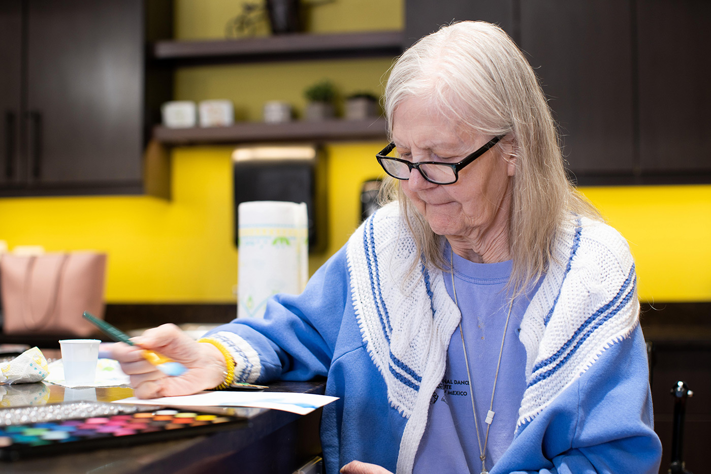 Resident enjoying a painting activity