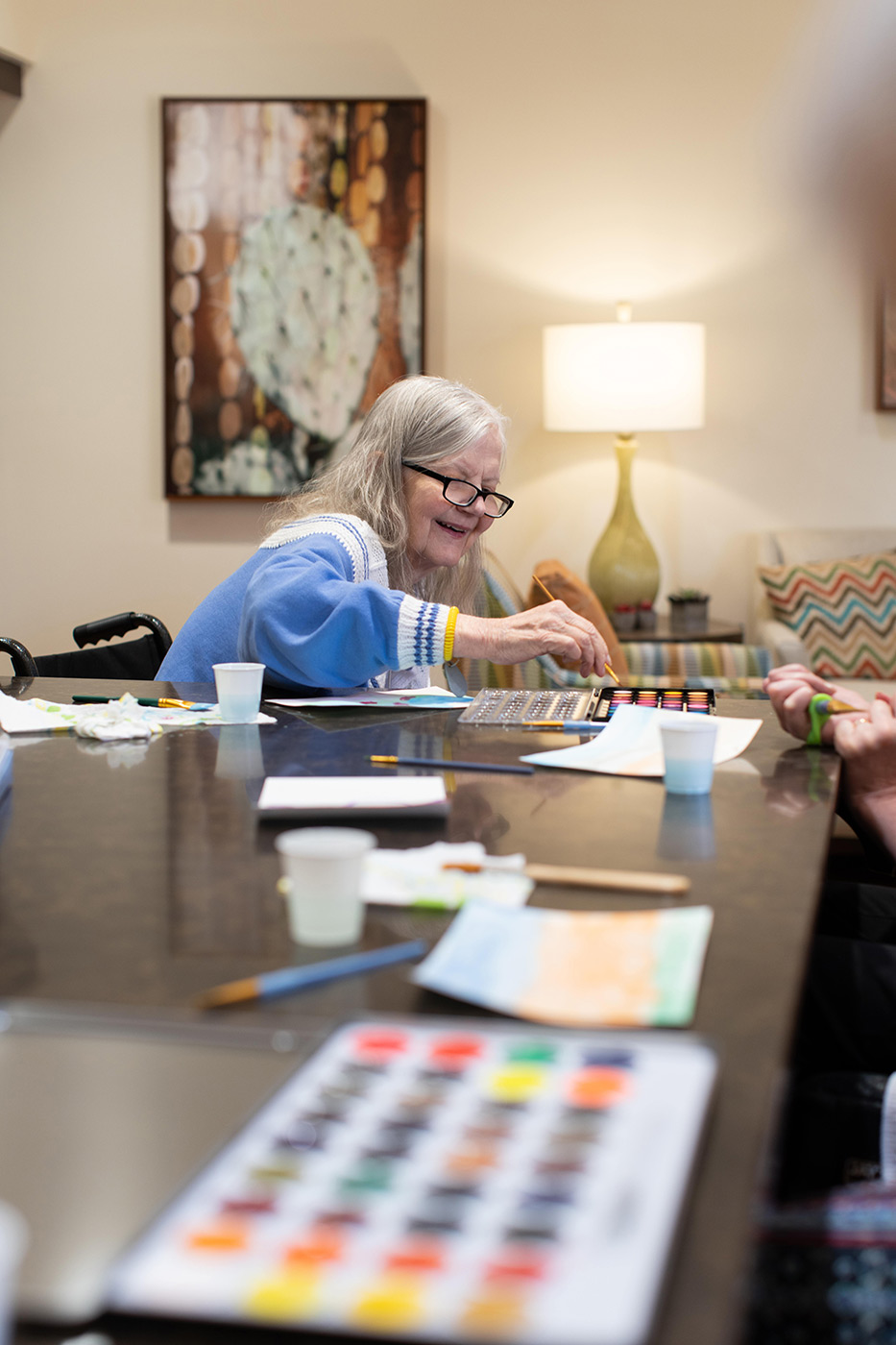 Resident enjoying a painting activity