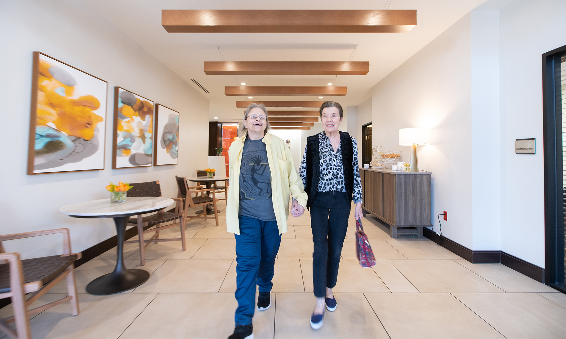 two residents strolling down the hallway