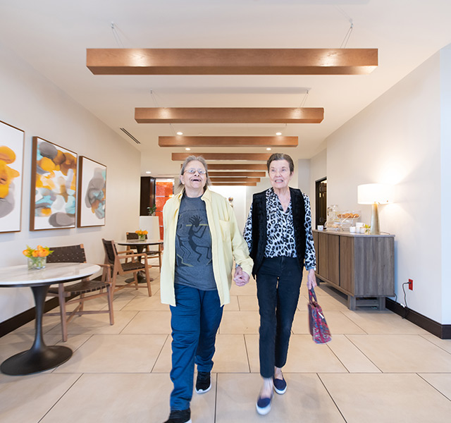 two residents strolling down the hallway