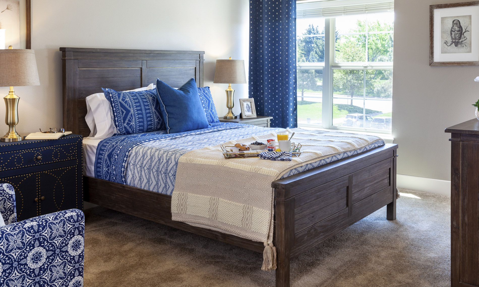 Bed room, with a bed including blue blankets and pillows