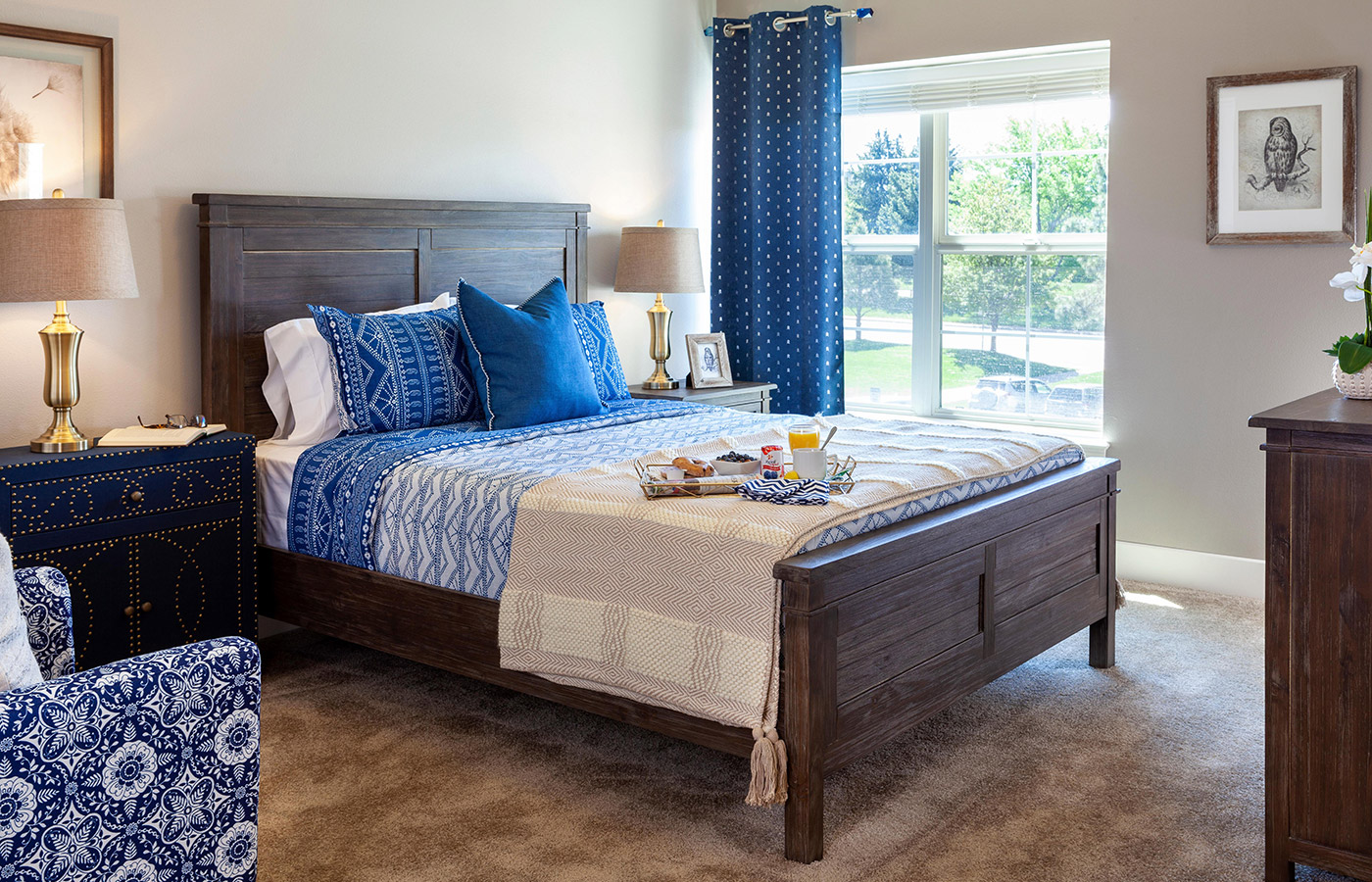 one of the 2 bedroom, including a a large bed with blue beddings with a bright window