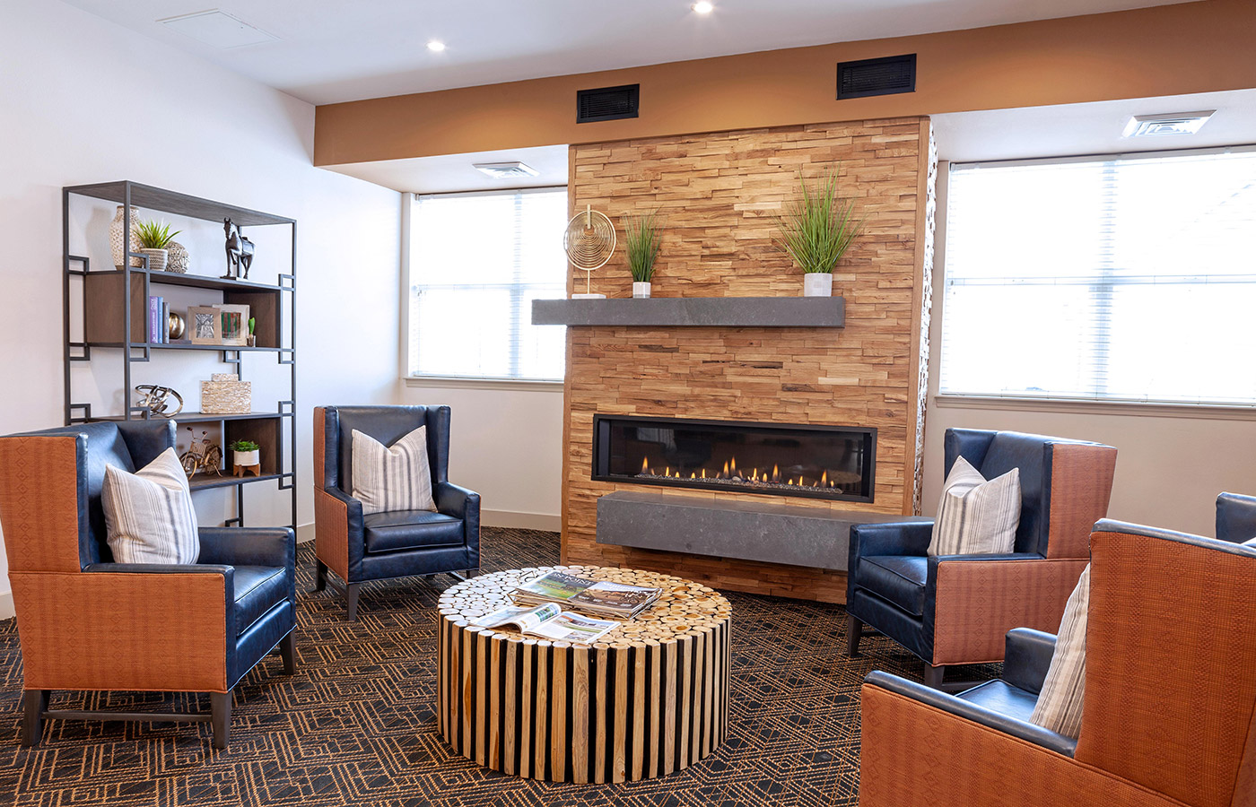 The lobby sitting area with comfortable chairs and fireplace