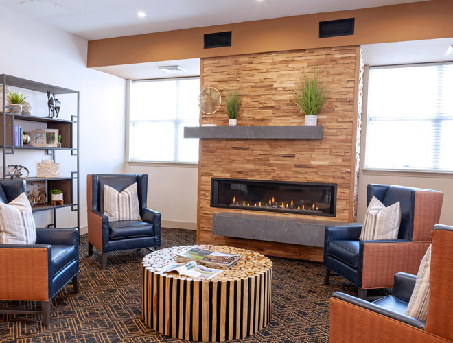 a few chaire in front of a fireplace