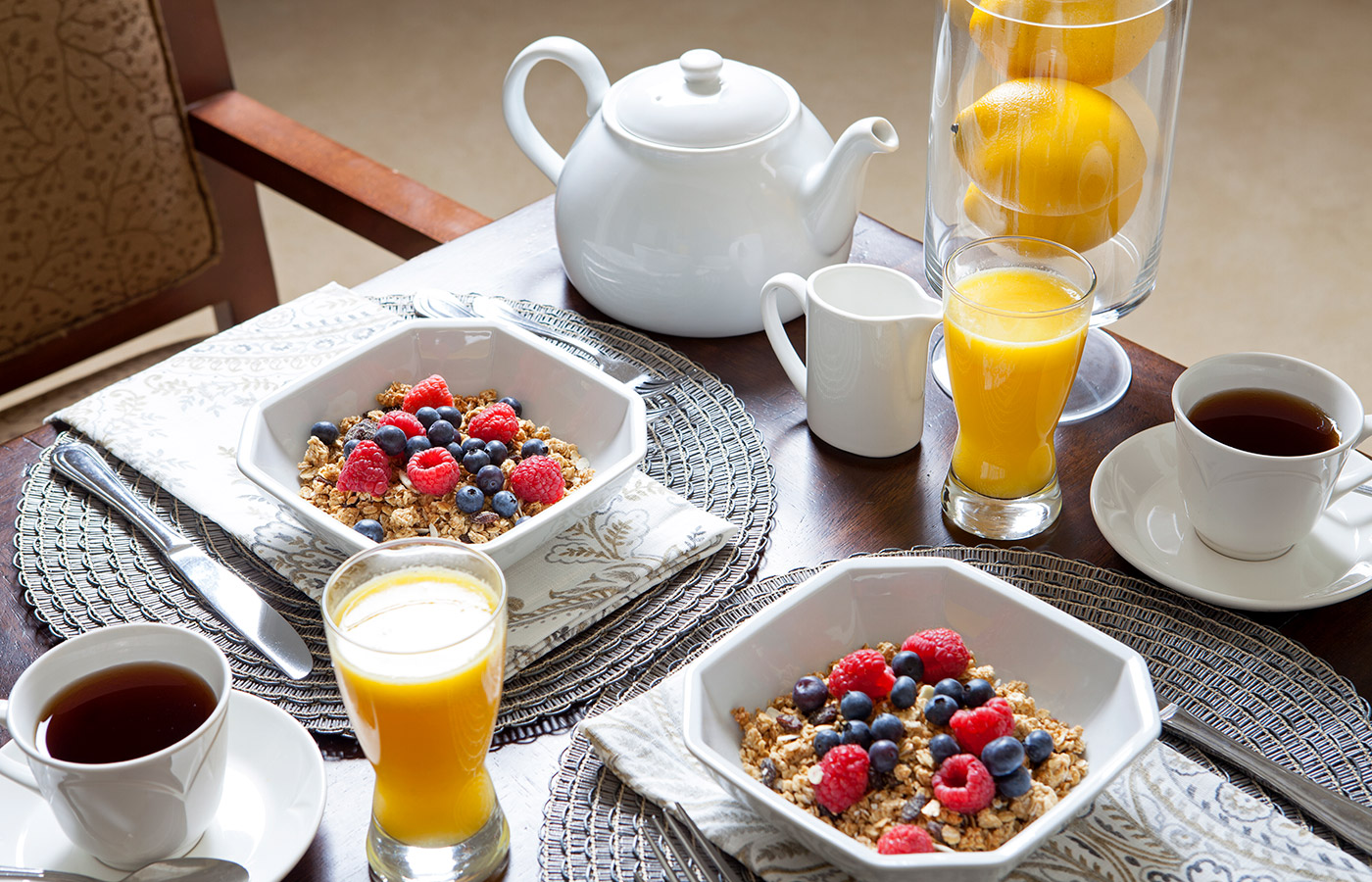 A welcoming breakfast made of fruit, granola and orange juice in champagne glasses