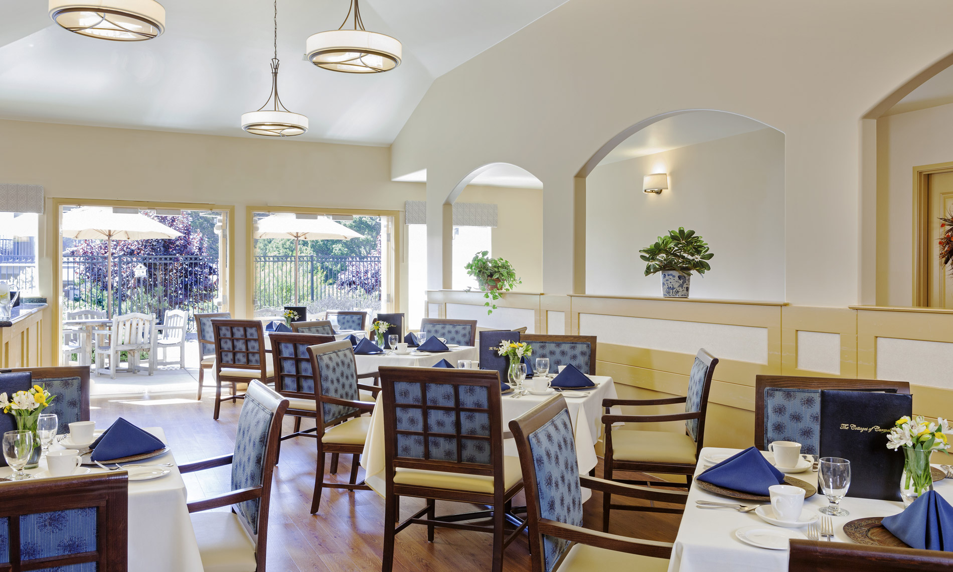 The dining room with chandeliers and well dressed tables