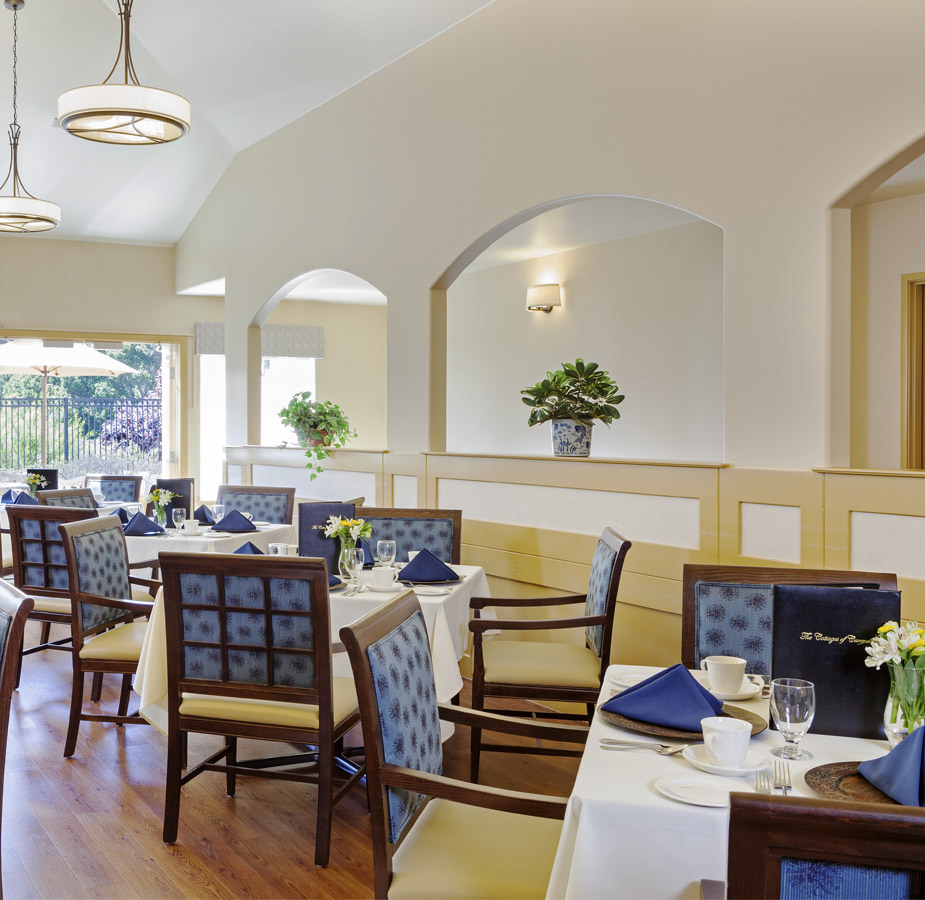 The dining room with chandeliers and well dressed tables