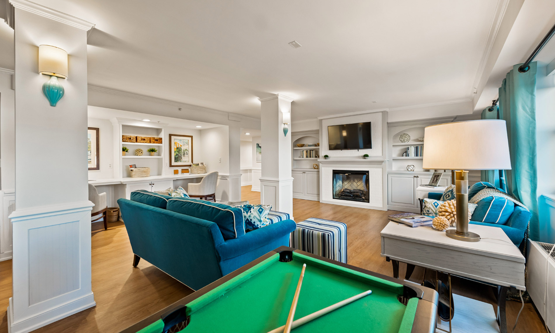 Amenities room with pool table fireplace and couches