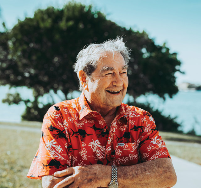 Men resident  outside smiling 
