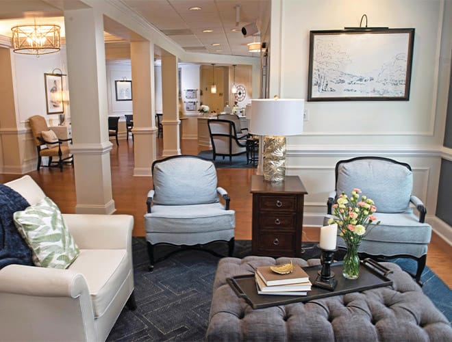 3 single chairs and an ottoman showcasing a portion of the Parlour at the Fountains at Albemarle 