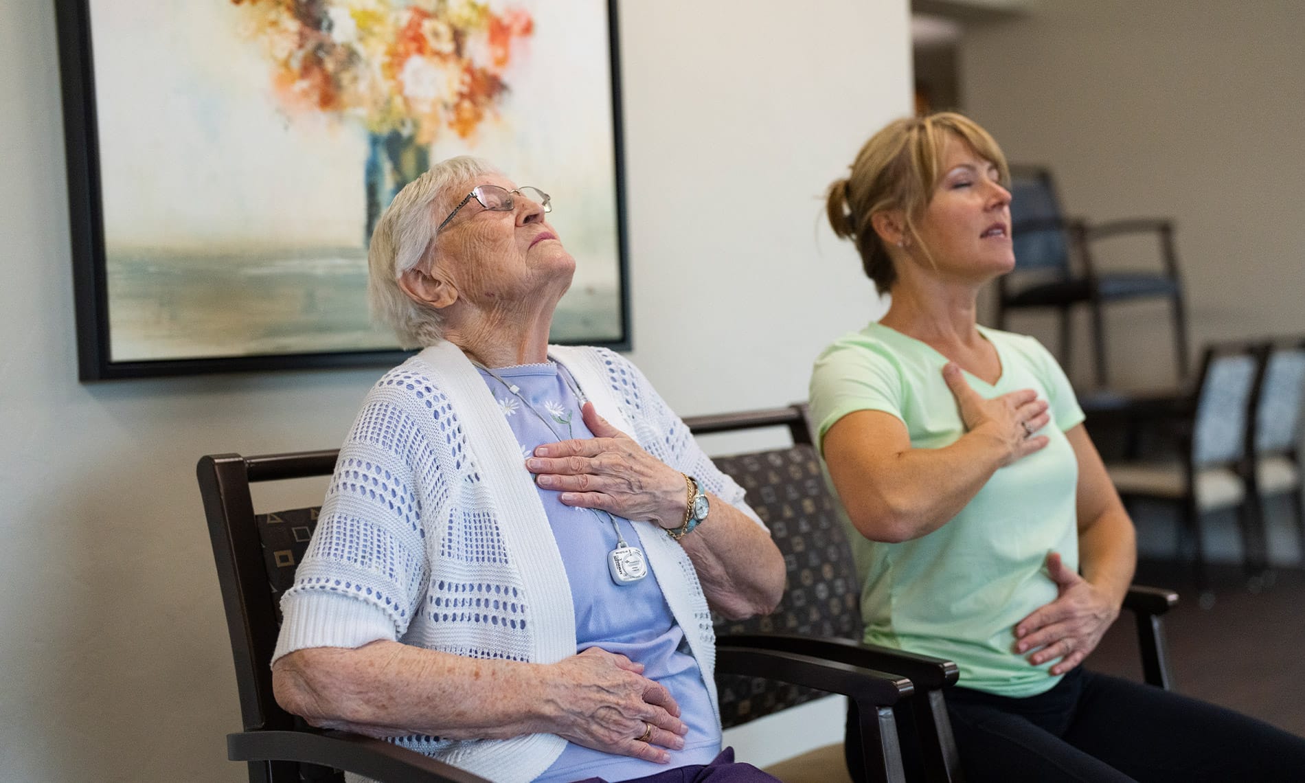 A resident and staff member practicing mindful meditation as party of the Signature Program offerings at the Fountains at the Albemarle