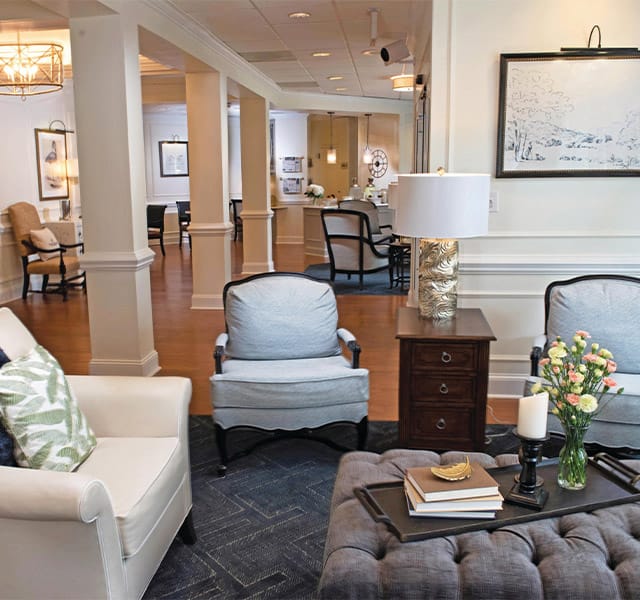 3 single chairs and an ottoman showcasing a portion of the Parlour at the Fountains at Albemarle 