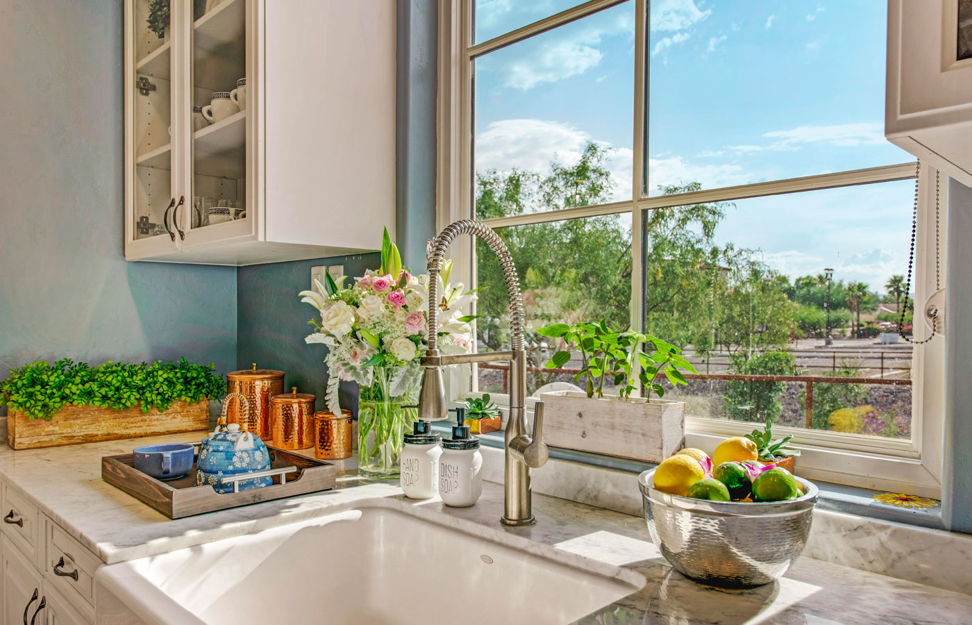 A farmhouse sink looking out to a bright blue sky at The Hacienda at the River