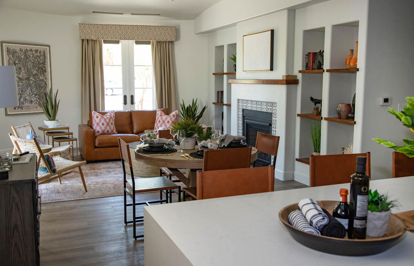 A bright living room with leather furniture and a wood burning fireplace found at The Hacienda at the River