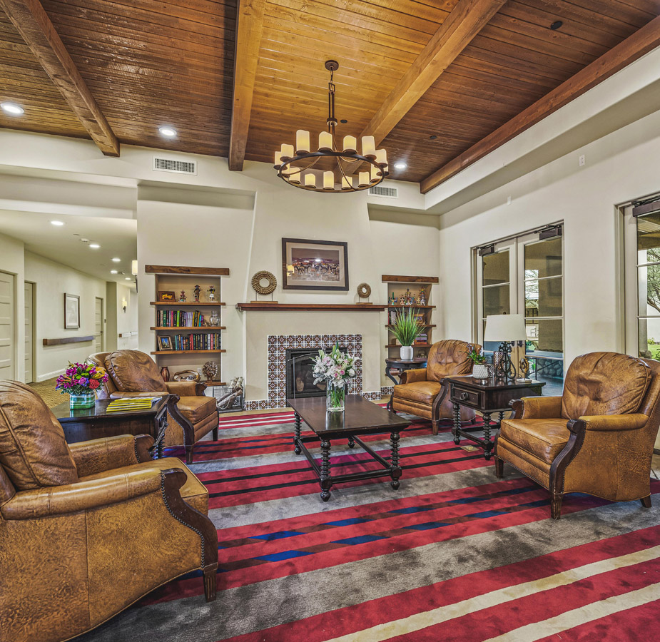 A communal common area with a variety of leather covered seating and tables at The Hacienda at the River