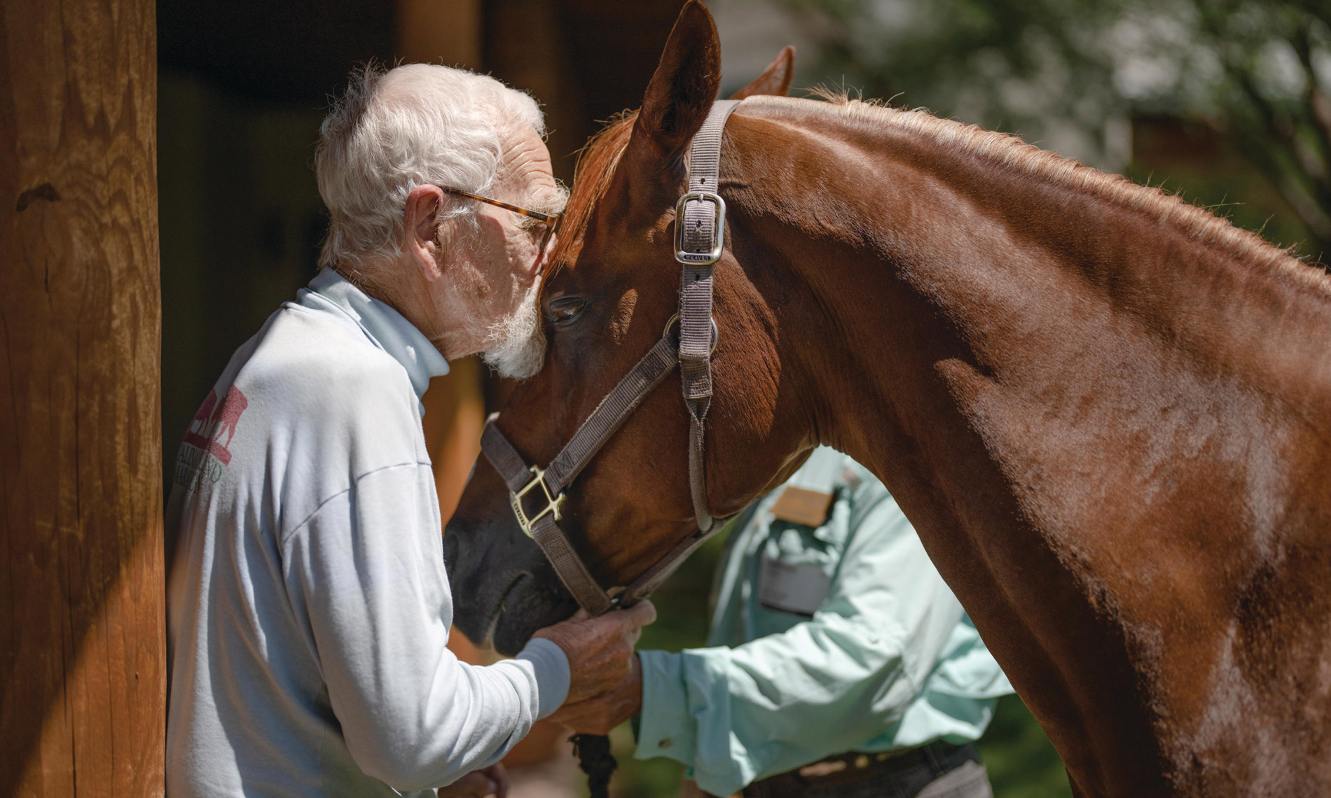 A resident and a horse at the stables at The Hacienda at the River