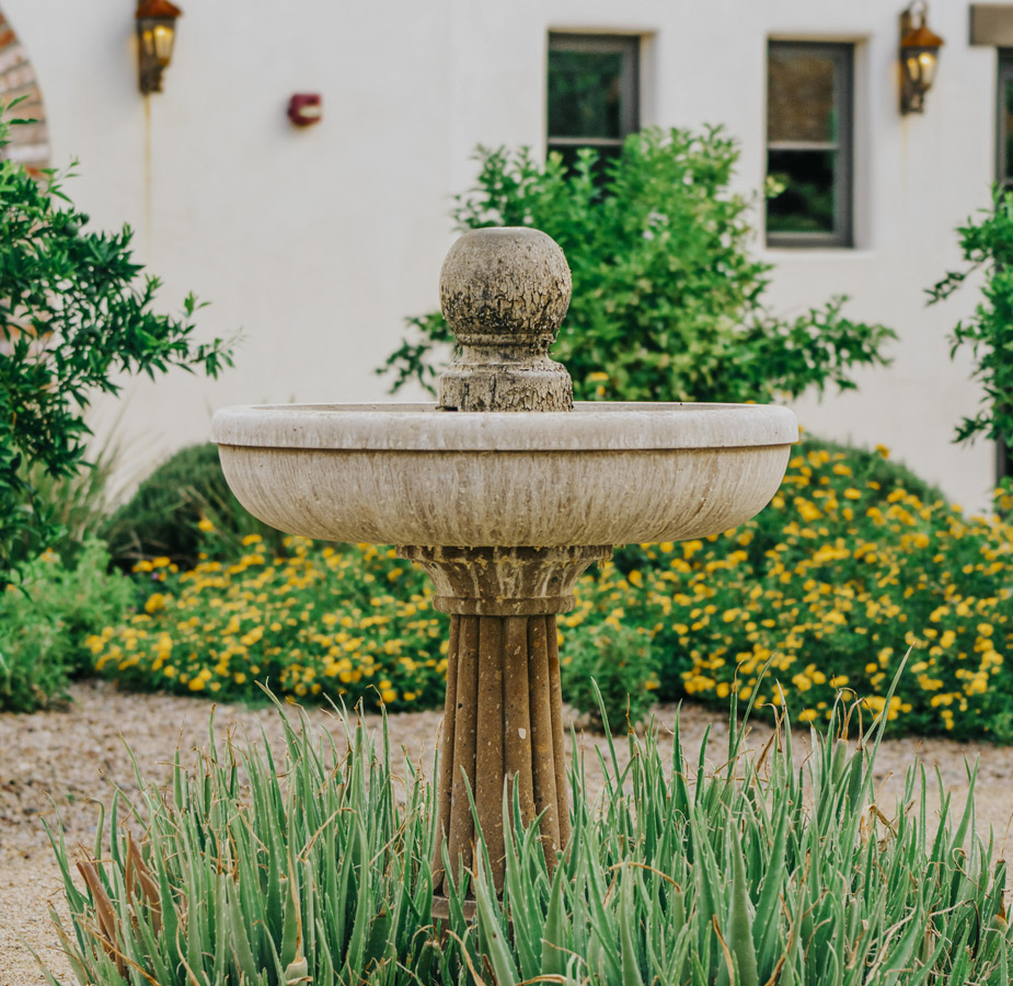 A water fountain sitting at the centre of a courtyard at The Hacienda at the River