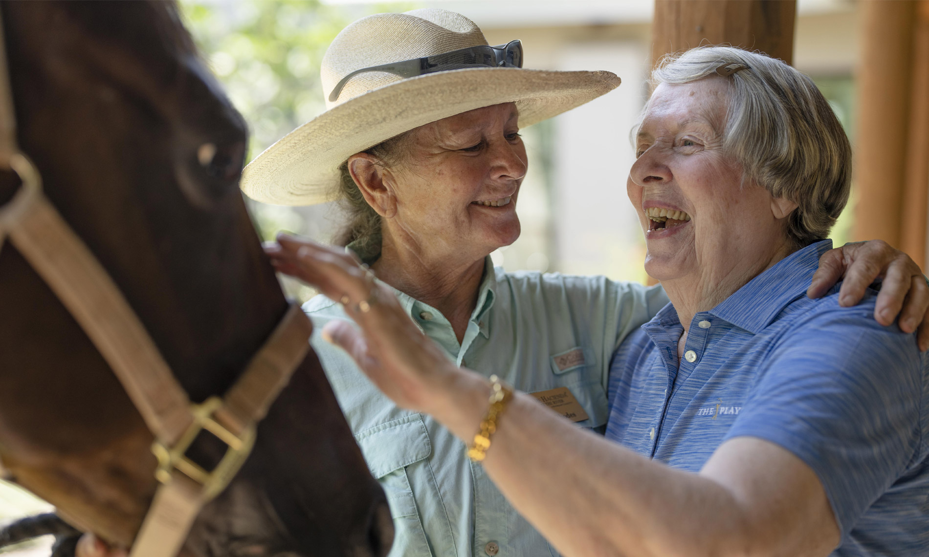 A resident and staff member in the stables at The Hacienda at the Rivers