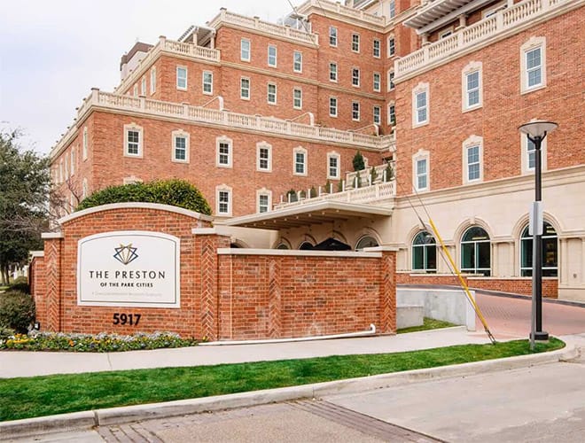 An exterior shot of the main entrance and exterior signage at the Preston of the Park Cities in Dallas Texas