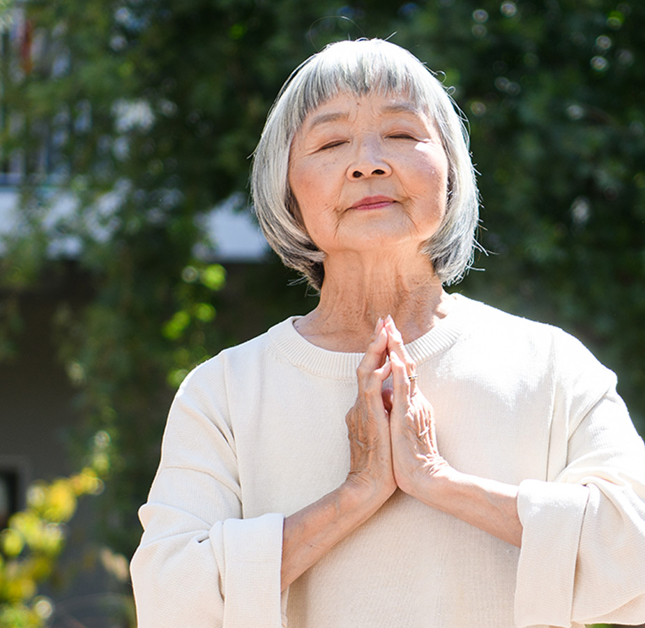 A resident in namaste pose