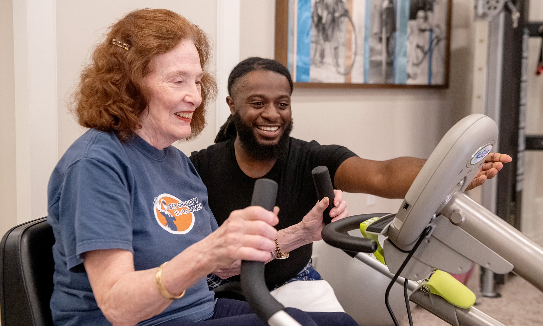Trainer orienting resident on fitness practice.