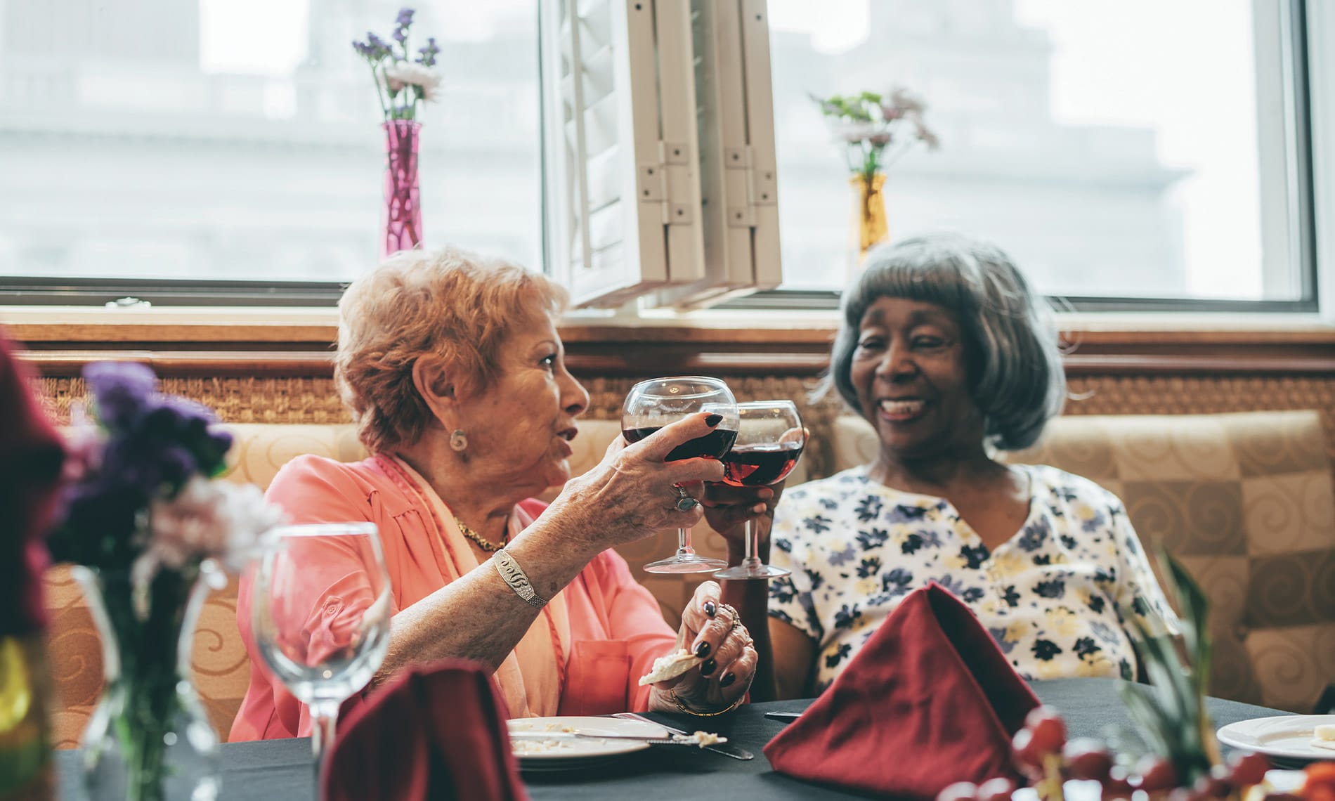 Elderly women enjoy a glass of wine
