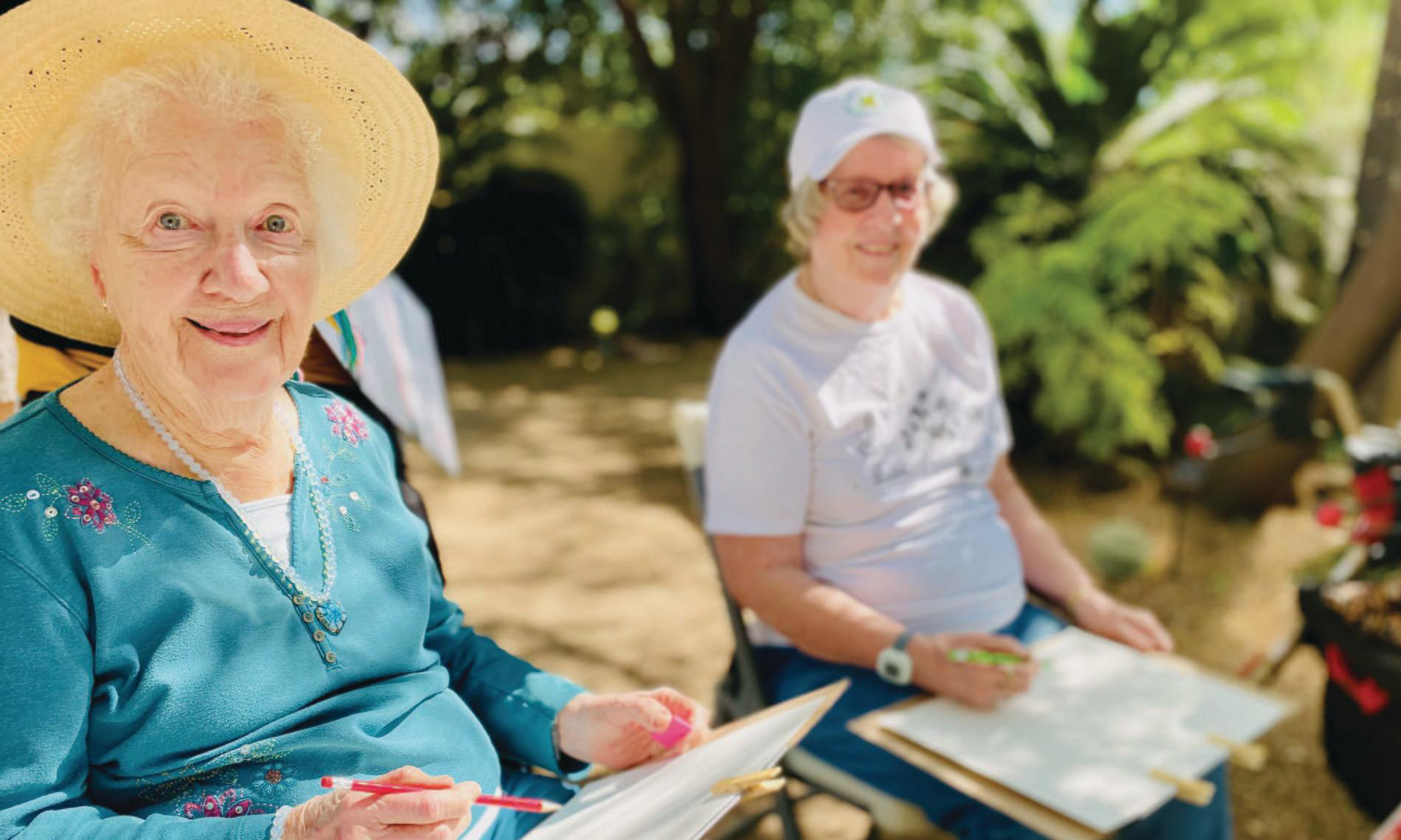 Residents enjoying a painting class outdoors at The Hacienda at the Rivers