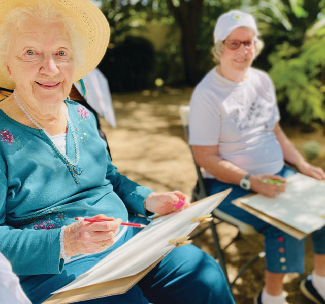 Residents enjoying an outdoor painting class at the The Hacienda at the Rivers