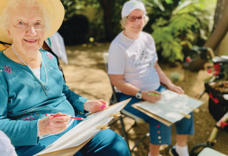 Residents enjoying an outdoor painting class at The Hacienda at the Rivers