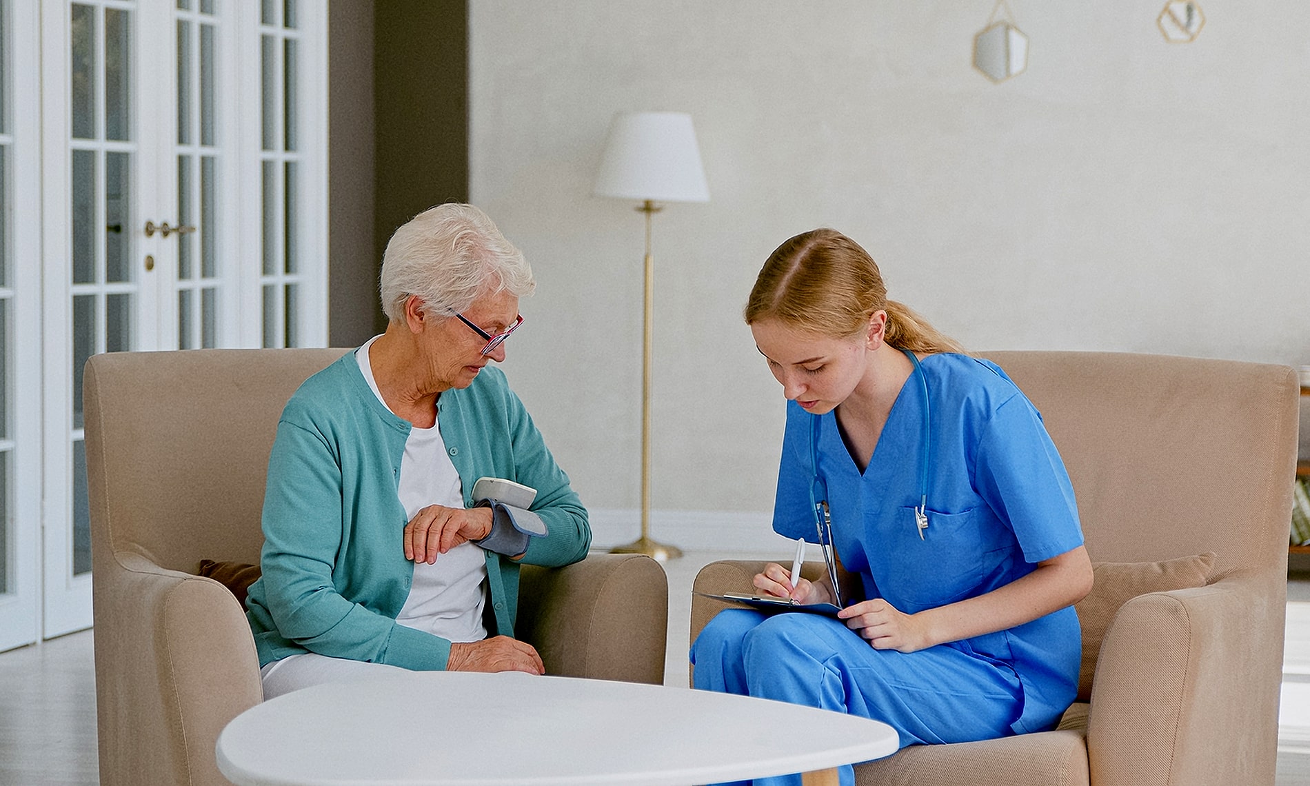 A resident sits with a nurse having her blood pressure checked as part of the skilled nursing program at the fountains at the albemarle 