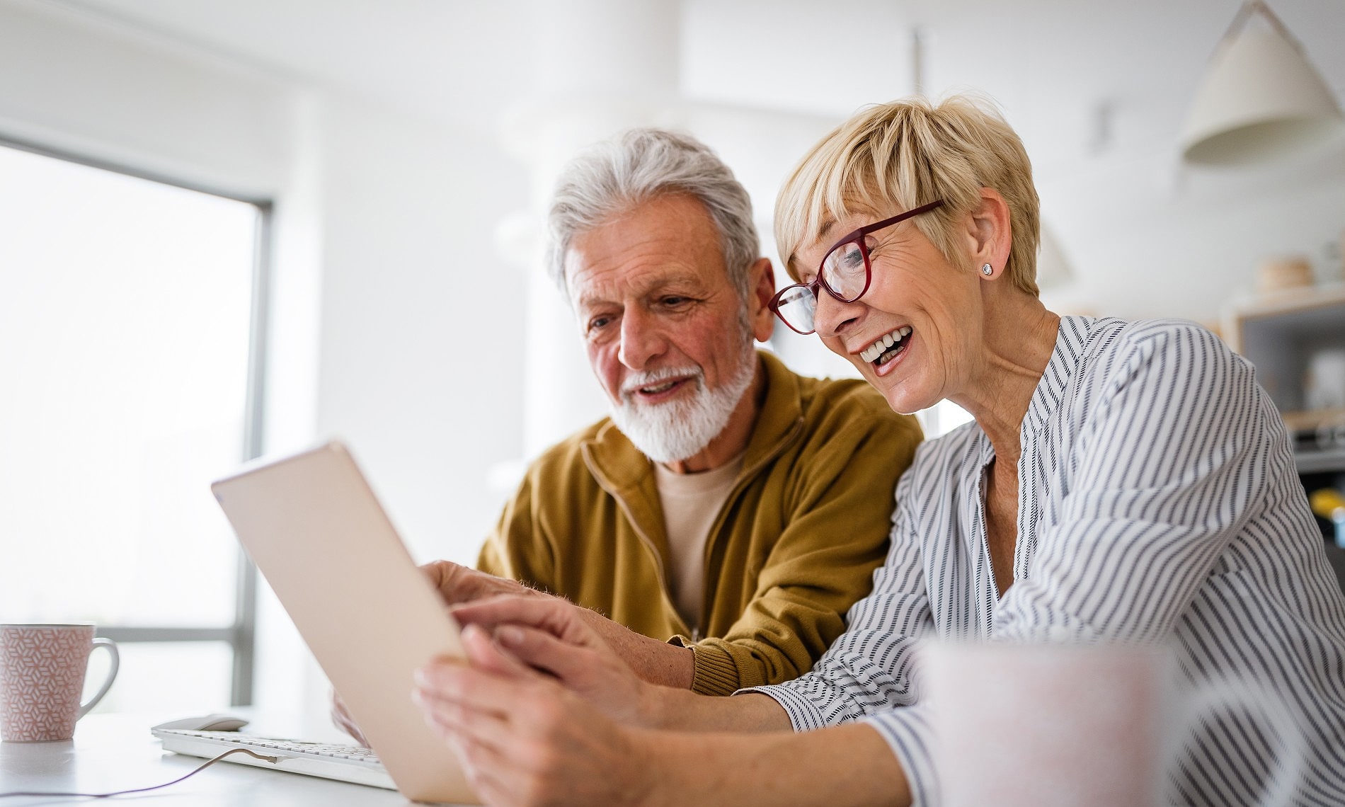 A man and a woman watching tablet