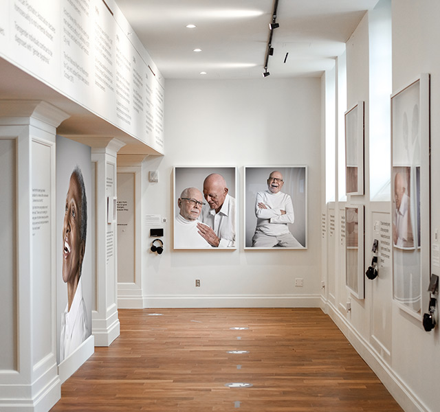 A shot of a Watermark property's lobby from above featuring a woman and her service dog talking a concierge. 