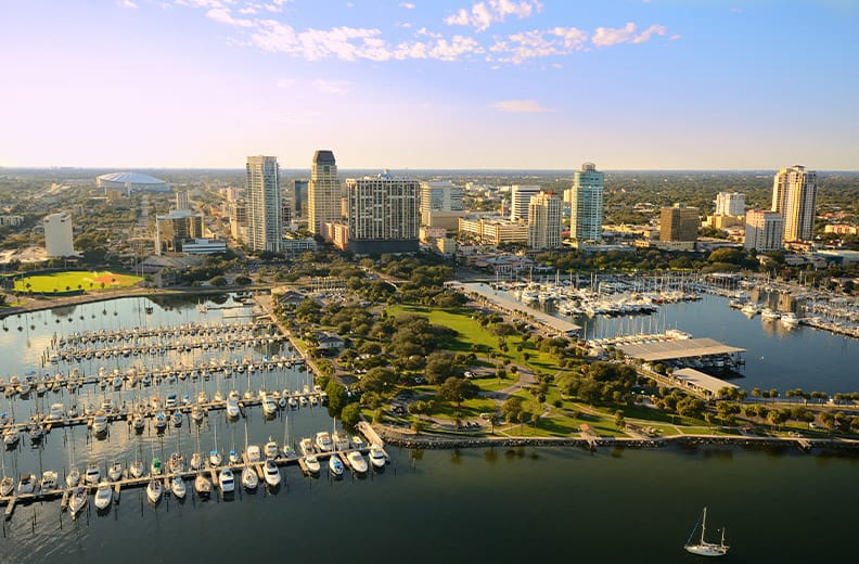 The marina in St. Petersburg, Fl with a partial view of residential towers and the Tampa skyline in the distance 