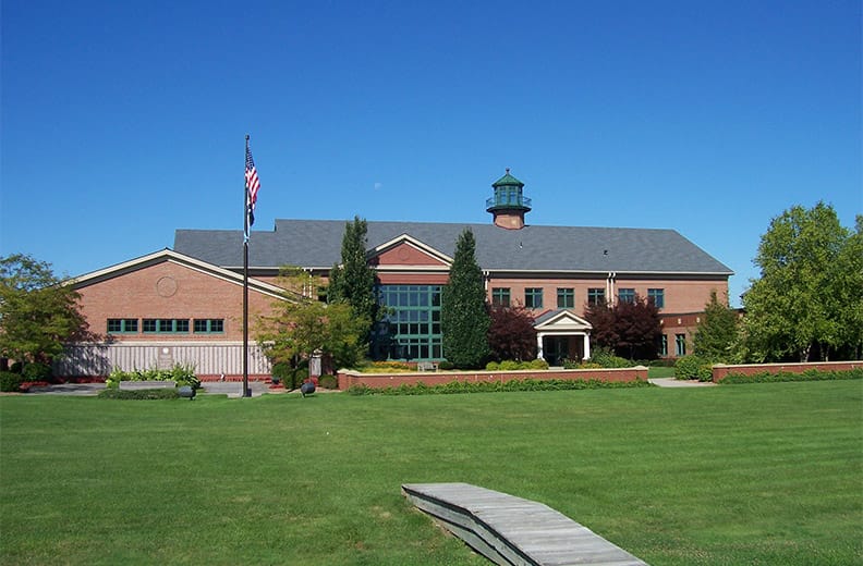 Town hall in Greece, NY with an American flag on the pole outfront