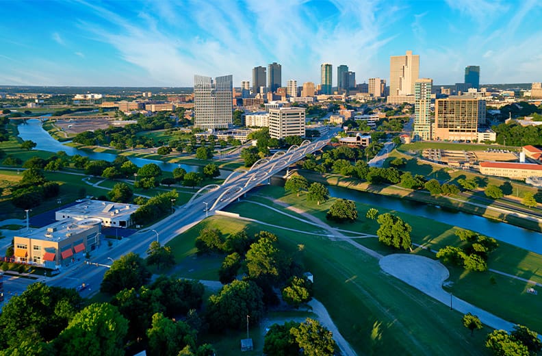 Aerial view of downtown Ft Worth Texas during the day with Trinity River in the foreground.