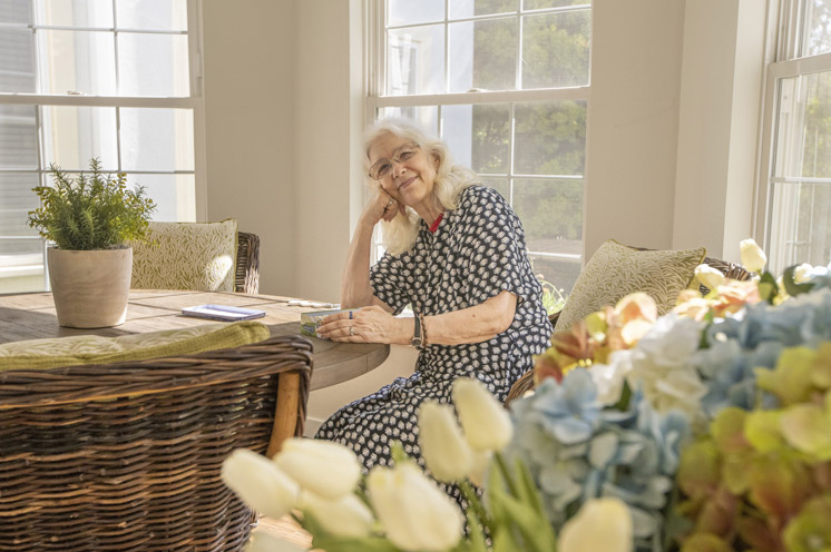Elderly woman sitting at a table