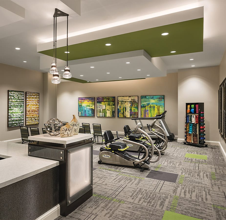 The Preston at the Park Cities Wellness First floor wellness room feature free weights and cardio equipment
