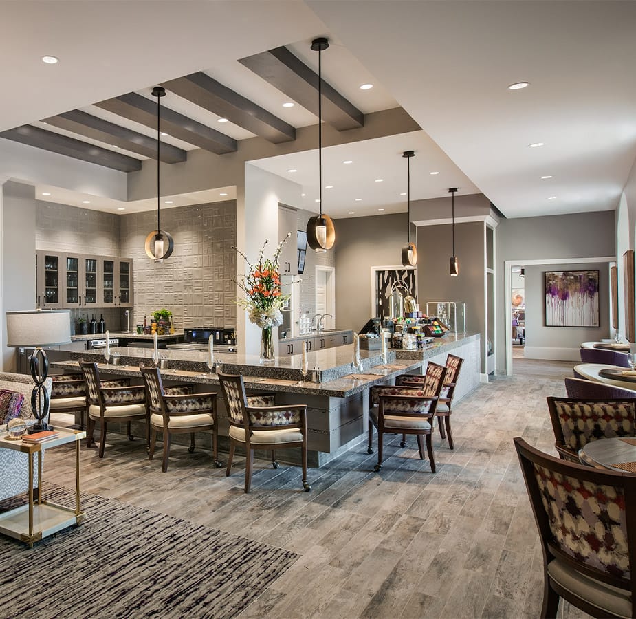 The Preston at the Park Cities Dining First floor bistro at the Preston at the Park Cities featuring seating at the bistro counter and chair and tables along a window