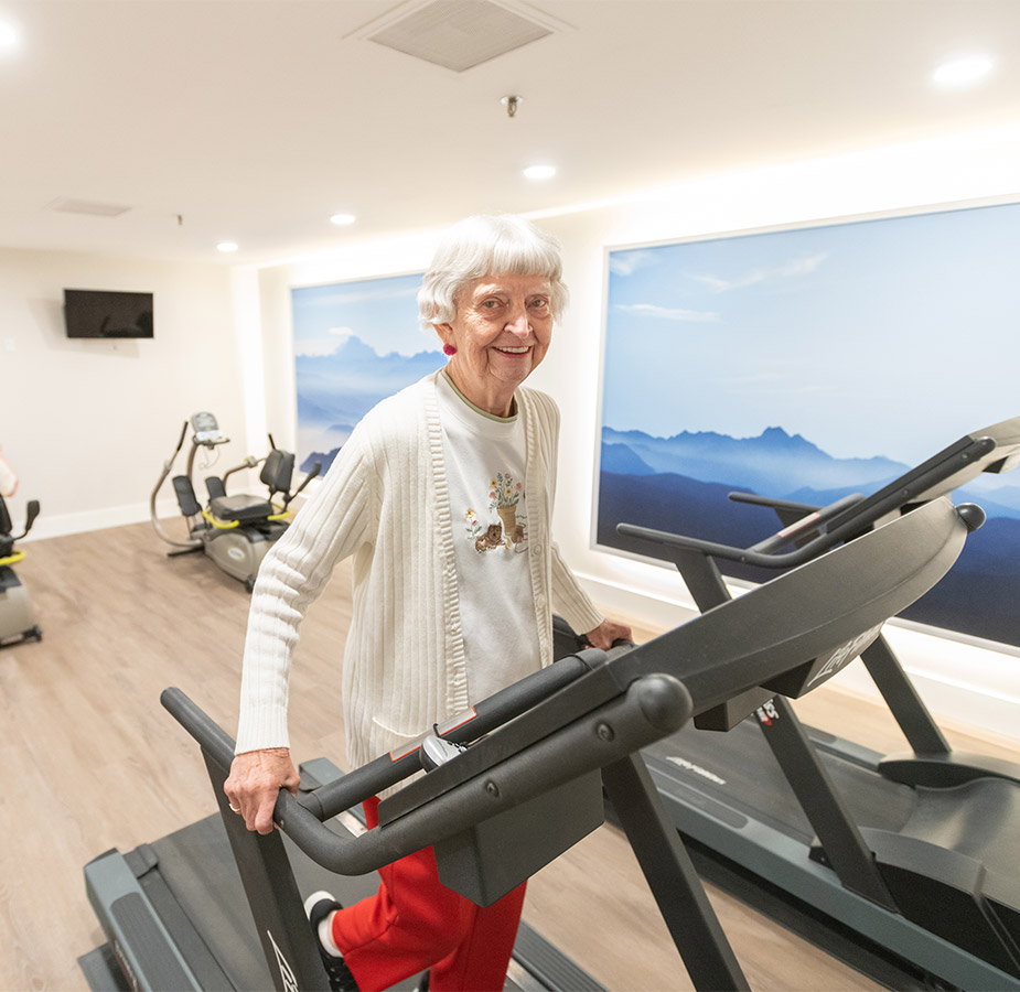 Elderly woman walking on a treadmill in the fitness centre Elderly woman walking on a treadmill in the fitness centre